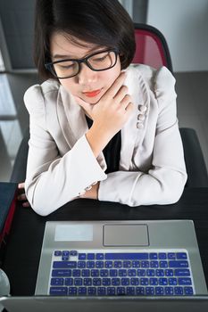 Young asian woman short hair in smart casual wear working on laptop in home office