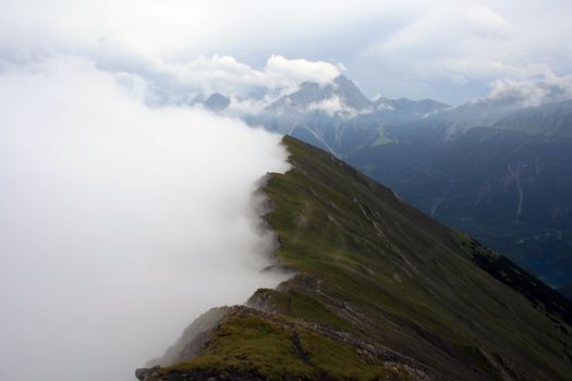 A view of the ridge of mountains losing in the fog