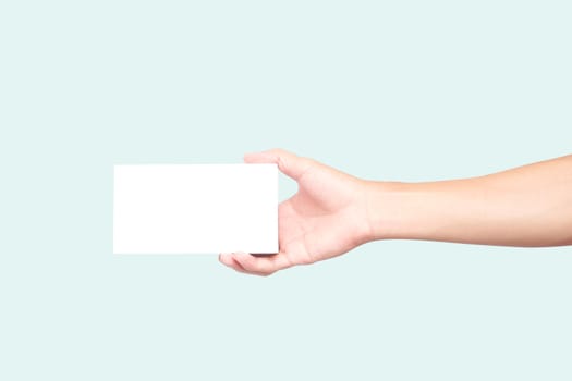Man hand holding white box on light blue background for text or advertising concept 