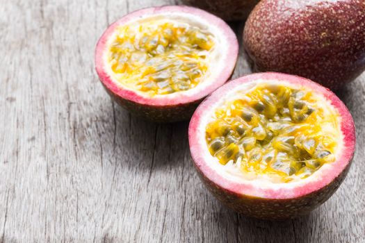 Closeup passion fruit with slice on wooden background, fruit healthy concept