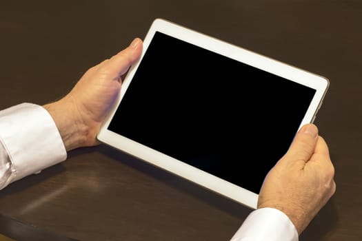 Businessman hands are holding the touch screen device.
