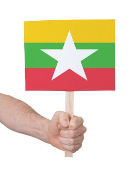 Hand holding small card, isolated on white - Flag of Myanmar