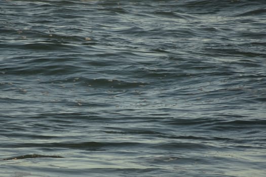 A background of sea water with calm surf