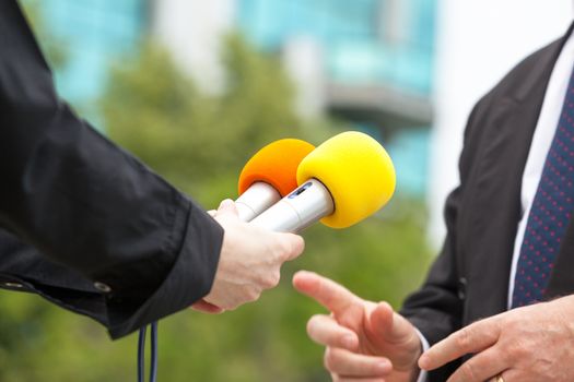 Female journalist conducting media interview with business person or politician