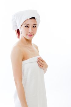 Asian American woman wrapped in towel on body and head