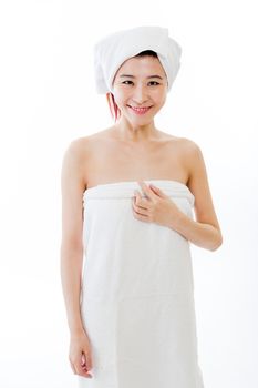 Asian American woman wrapped in towel on body and head