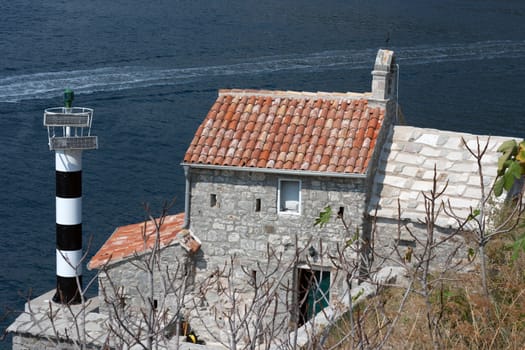 Lighthouse and medieval church,bay of Kotor, MontenegroBay of Kotor, Montenegro - Lighthouse and medieval church Our Lady of The Angel Gospa od Andjela