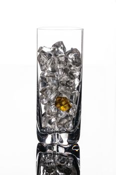 Crystals of ice in a glass with water on a glass background