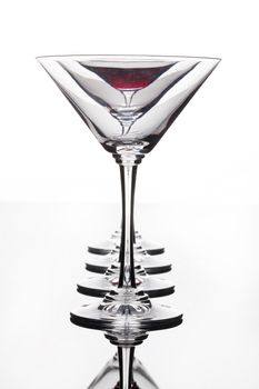 Glass with a red wine on a glass studio background