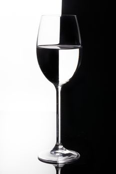 Glass with a red wine on a glass studio background
