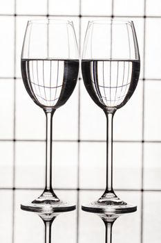 Glass with a red wine on a glass studio background