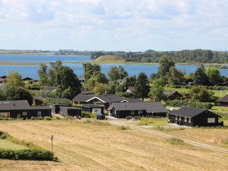 Aeriel View over Black Summer Wooden Houses and Sea