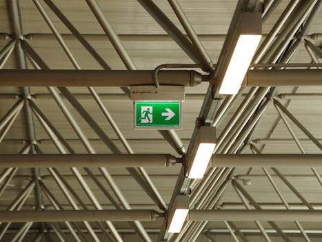 Green Emergency Exit Sign under Roof with Lamps