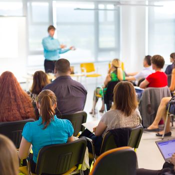 Speaker at business workshop and presentation. Audience at the conference room.