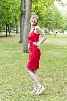 Beautiful lady in red are standing at the summer day