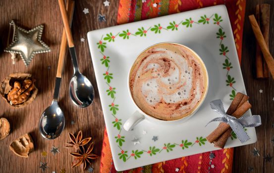 Cup of coffee and Christmas decorations on wooden table