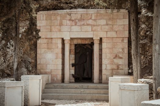 Entrance to an old small private bricks stone tomb carved into the mountain in israel