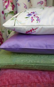 Selection of colorful pillows in retail store, close up, low angle view