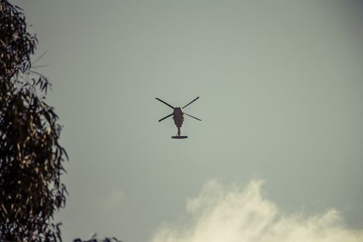 Israeli military UH-60 Black Hawk helicopter flying in the sky. Low angle view.