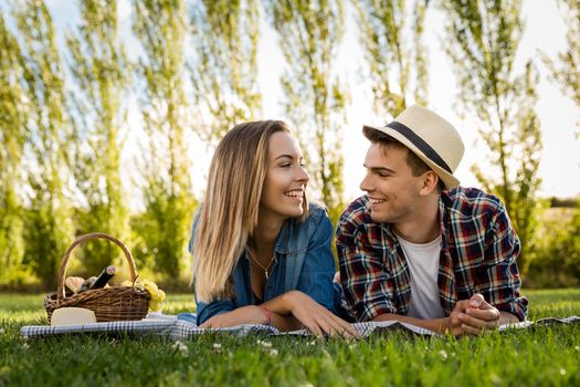 Shot of a beautiful couple on the park having fun together while making a picnic