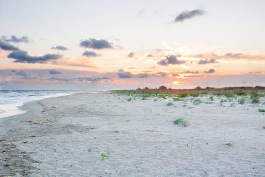 Sandy empty sea coastal seaview, cloudy colourful sunrise sky view