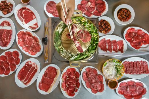 Asian BBQ-Style. Grill sliced beef on hot pan with vegetable