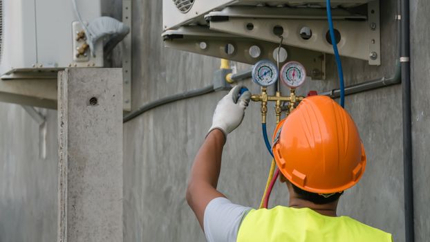 Technician is checking outdoor air conditioner unit