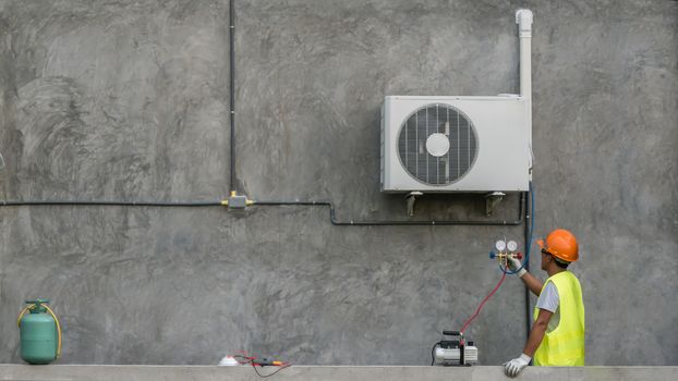 Technician is checking outdoor air conditioner unit