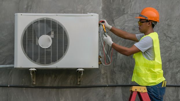 Technician is checking outdoor air conditioner unit