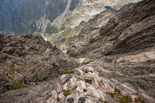 Stunning view from the steep cliff near upper station of the cable railway on Lomnicky Stit peak in High Tatra mountains, Slovakia, Europe.