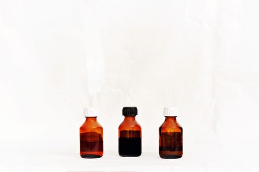 Three bottles with medicinal tinctures isolated white background.