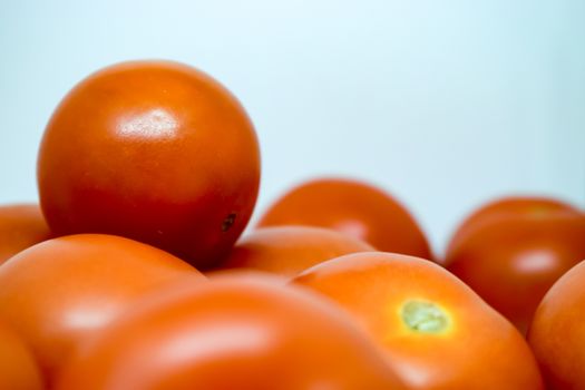 Bright Red Tomatoes on a white background nothing else