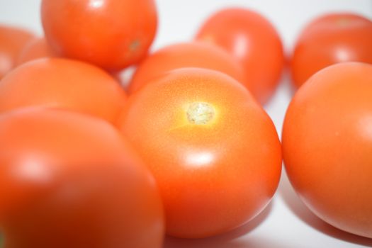 Bright Red Tomatoes on a white background nothing else