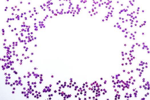 Purple glitter stars on a white background with copy space