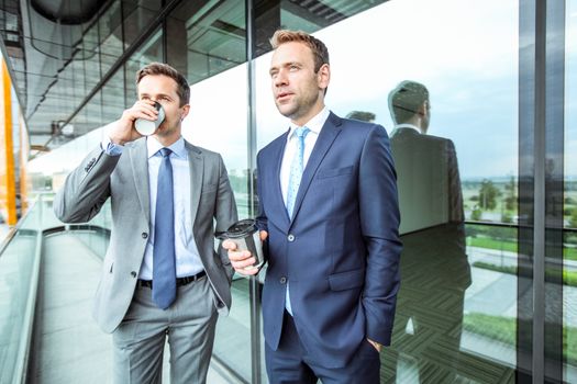 Business people having coffee break at the balcony of office building