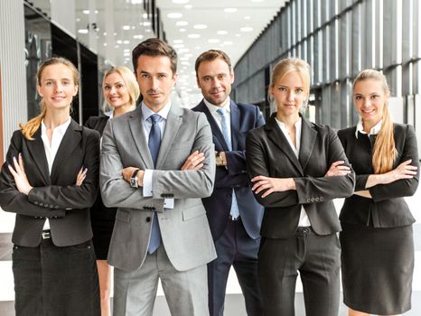 Portrait of successful business people team standing together in modern office building