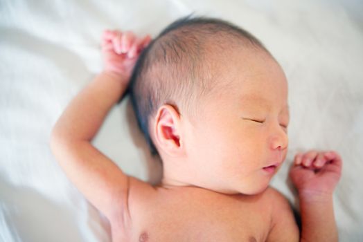 Cute Asian newborn baby sleeping, 7 days old.