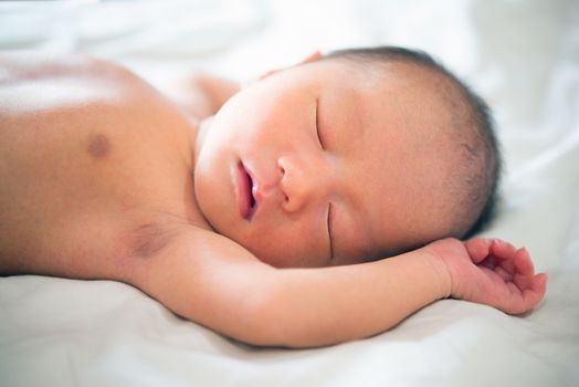 Cute Asian newborn baby sleeping.