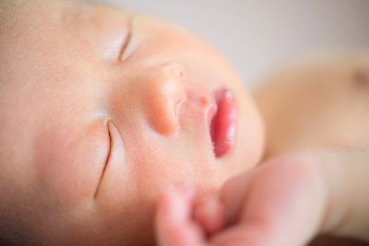 Close up sleeping Asian newborn baby boy, 1 week old.