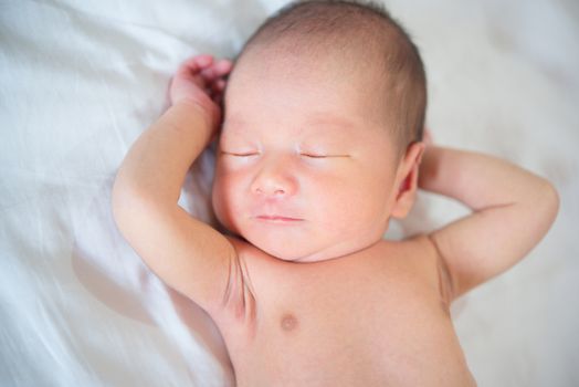 Cute Asian newborn baby sleeping, 1 week old.