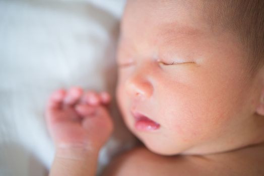 Close up cute Asian newborn baby sleeping, 1 week old.