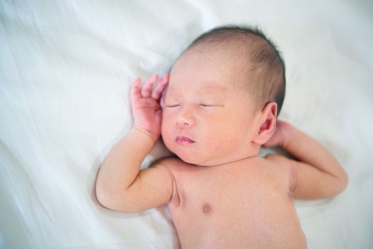 Close-up portrait of a beautiful sleeping baby boy, 1 week old.