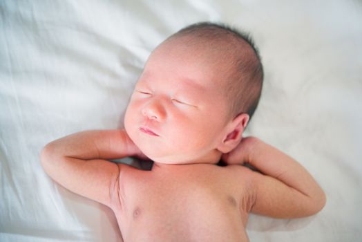 Sleeping Asian new born baby boy, 1 week old.