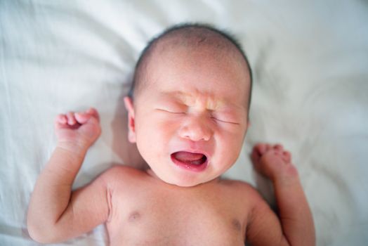 Newborn baby is crying and screaming because stomach hurts. 