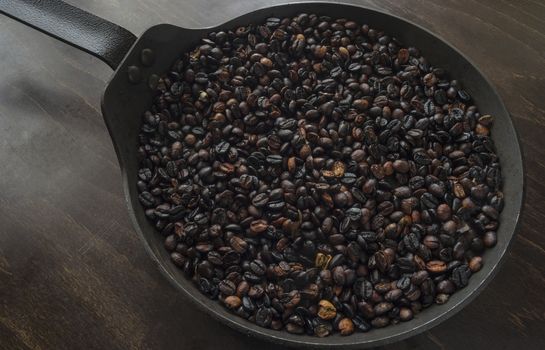 A pan with freshly brewed ground coffee beans.