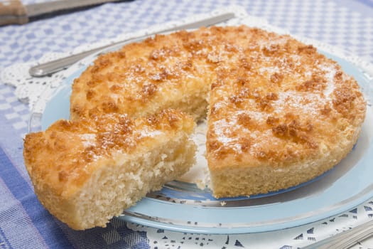 Close up view of sliced piece of  a tasty coconut crumble cake.