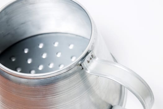 Close view of a metal rustic chestnut roaster isolated on a white background.