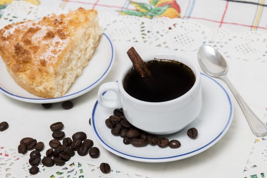 Close view of breakfast with coffee and a piece of coconut cake.