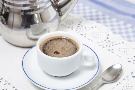 Composition of the classic coffee cup espresso on a table.
