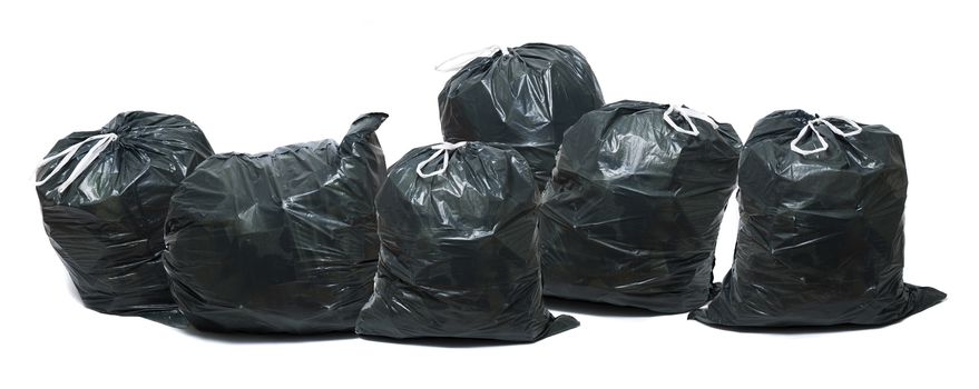 Group of green trash bags isolated on a white background.